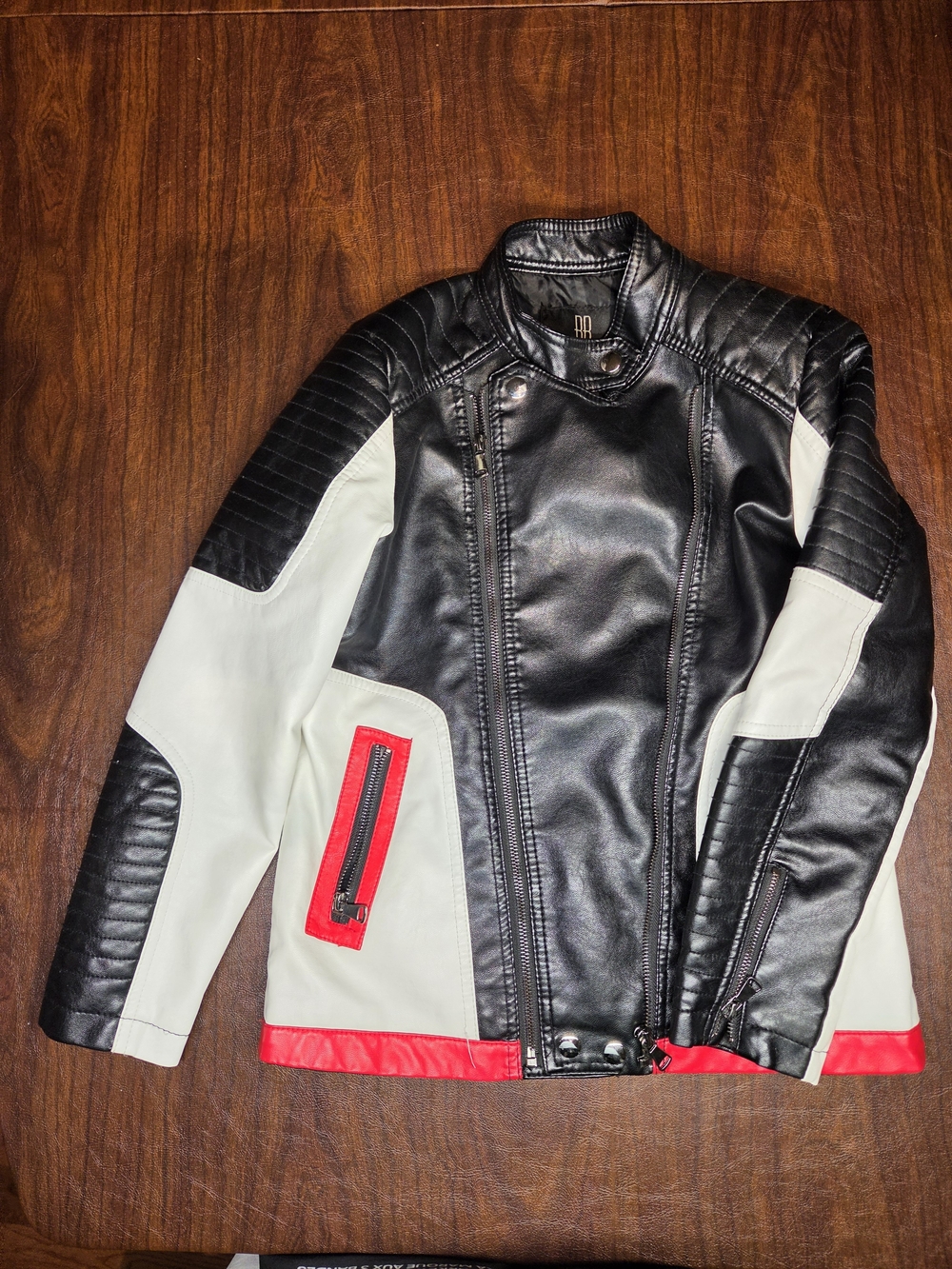Buderim kids moto-style faux leather jacket in black, cream/white and red. Youth